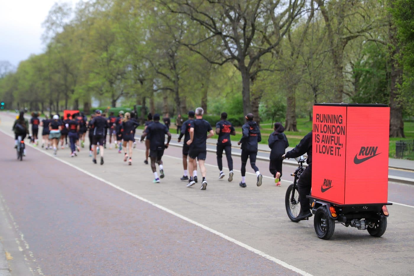 Nike Digital AdBike Pacer riding alongside runners in central London