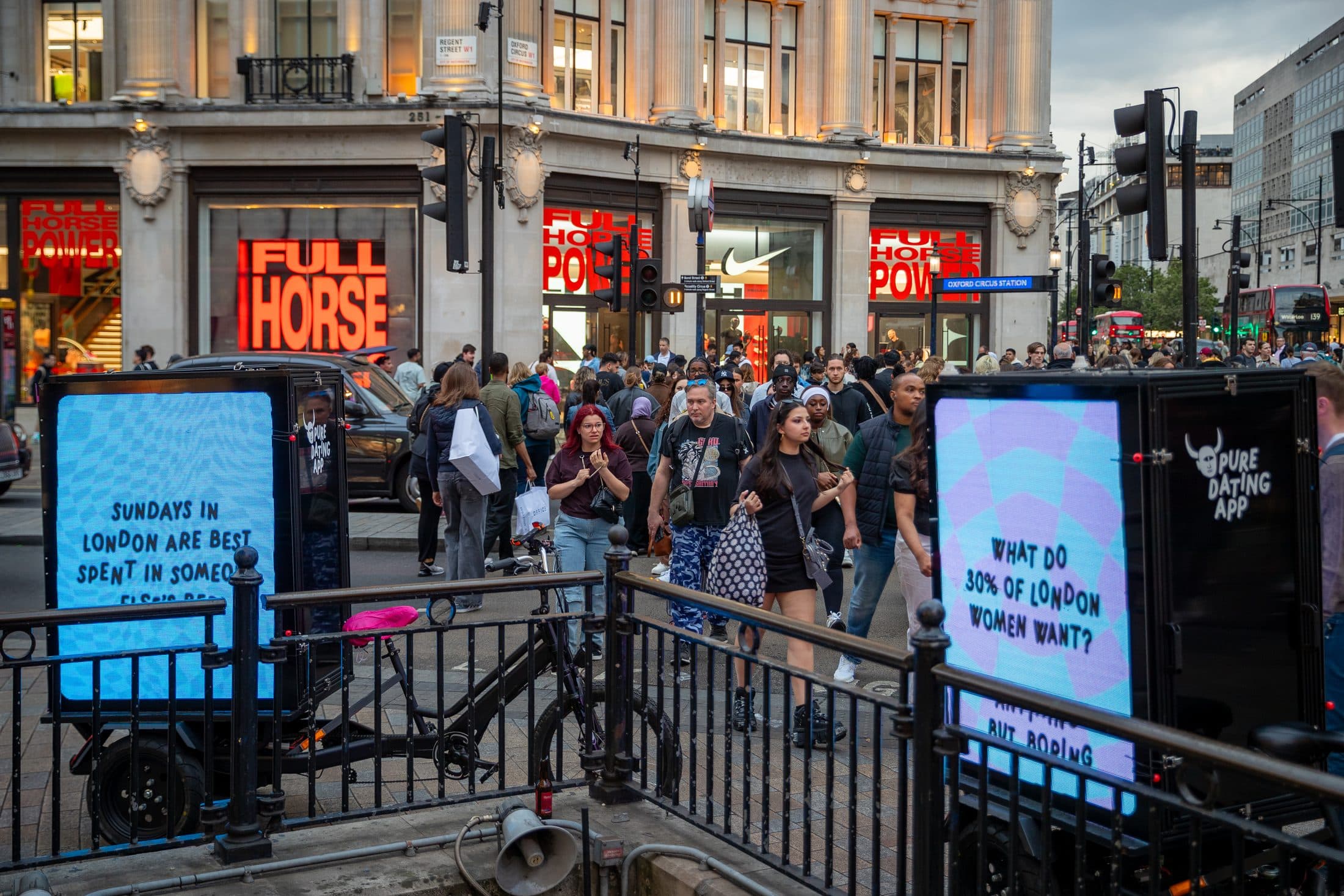 Digital AdBike advertising passing the crowds at Oxford Circus in Central London