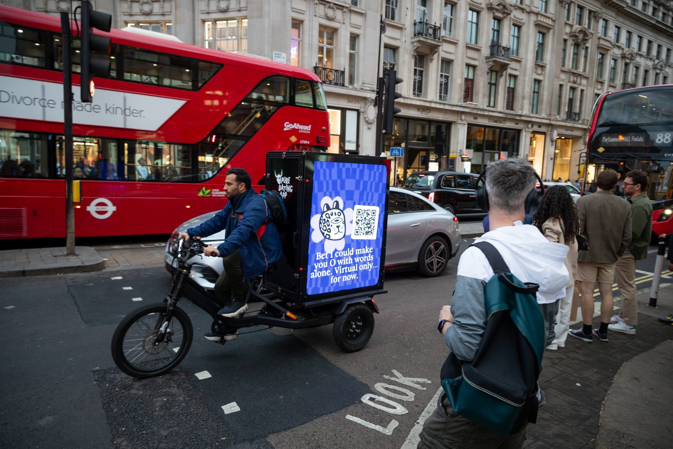 Scooter rider passing the Pure Digital AdBike in central London