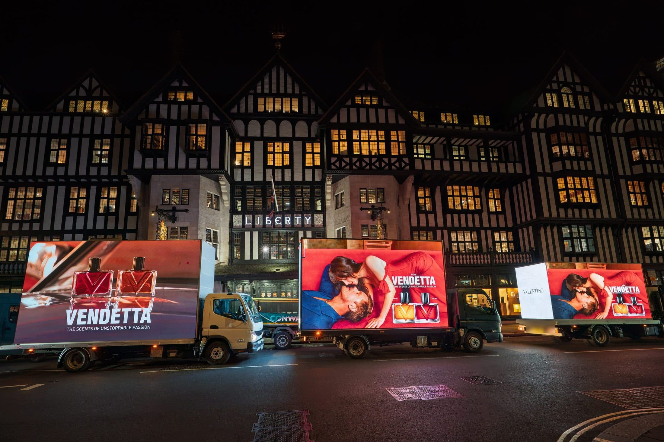 Three Monster Digital AdVans lined up outside Liberty at night carrying the Valentino Vendetta campaign