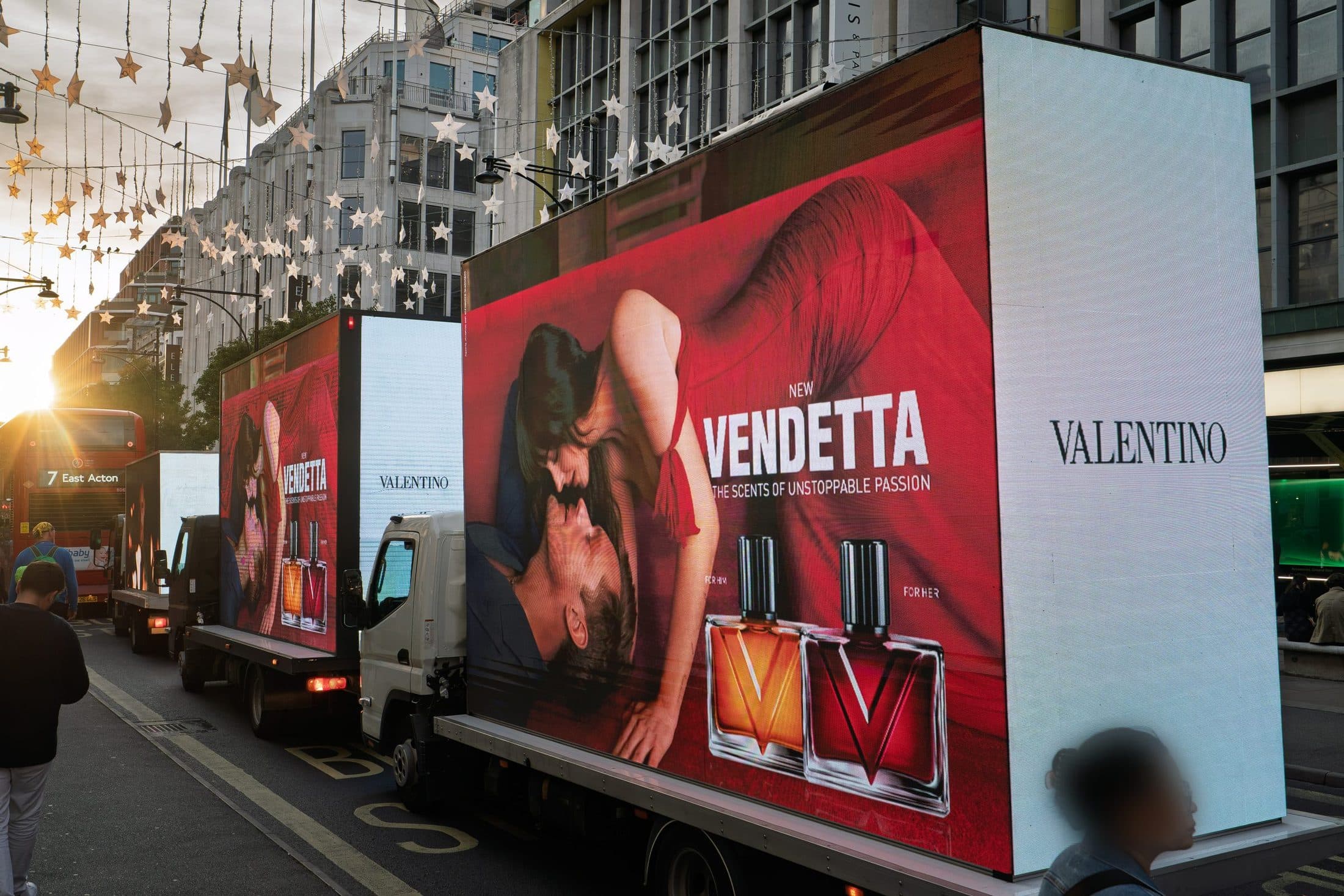 Two Monster Digital AdVans carrying the Valentino Vendetta campaign through Oxford Circus at sunset under the star lights