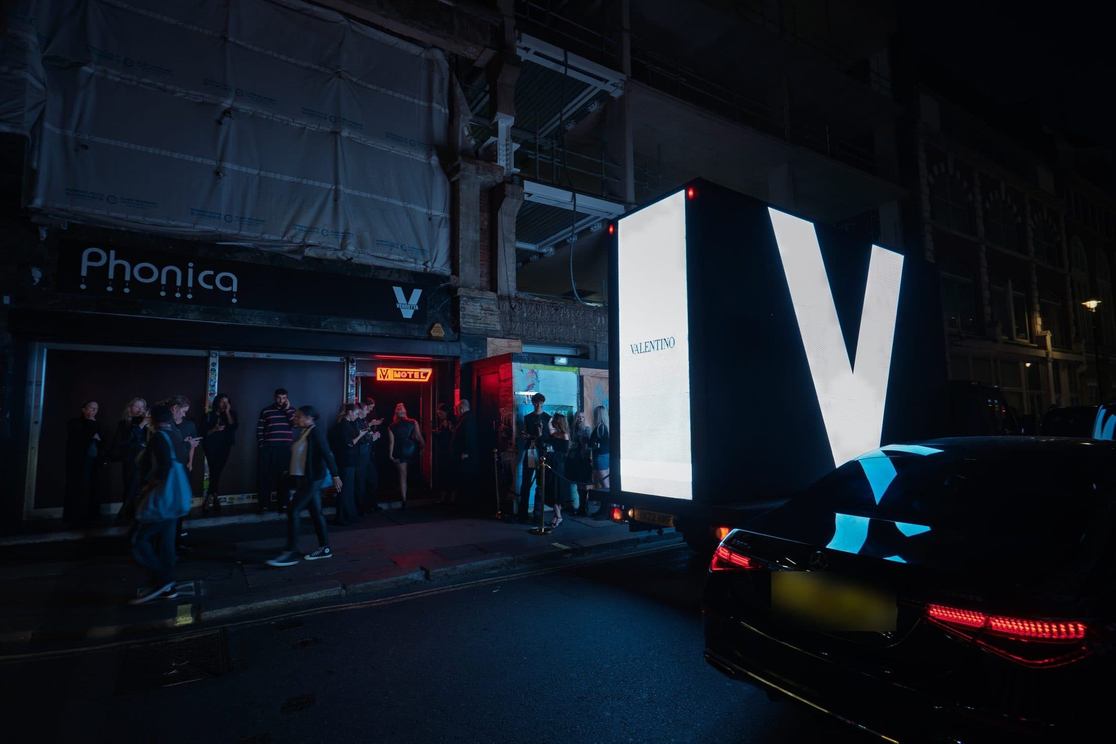 The giant white V on the back of a Monster Digital AdVan passing the Valentino Vendetta launch party at Phonica on Poland Street, Soho