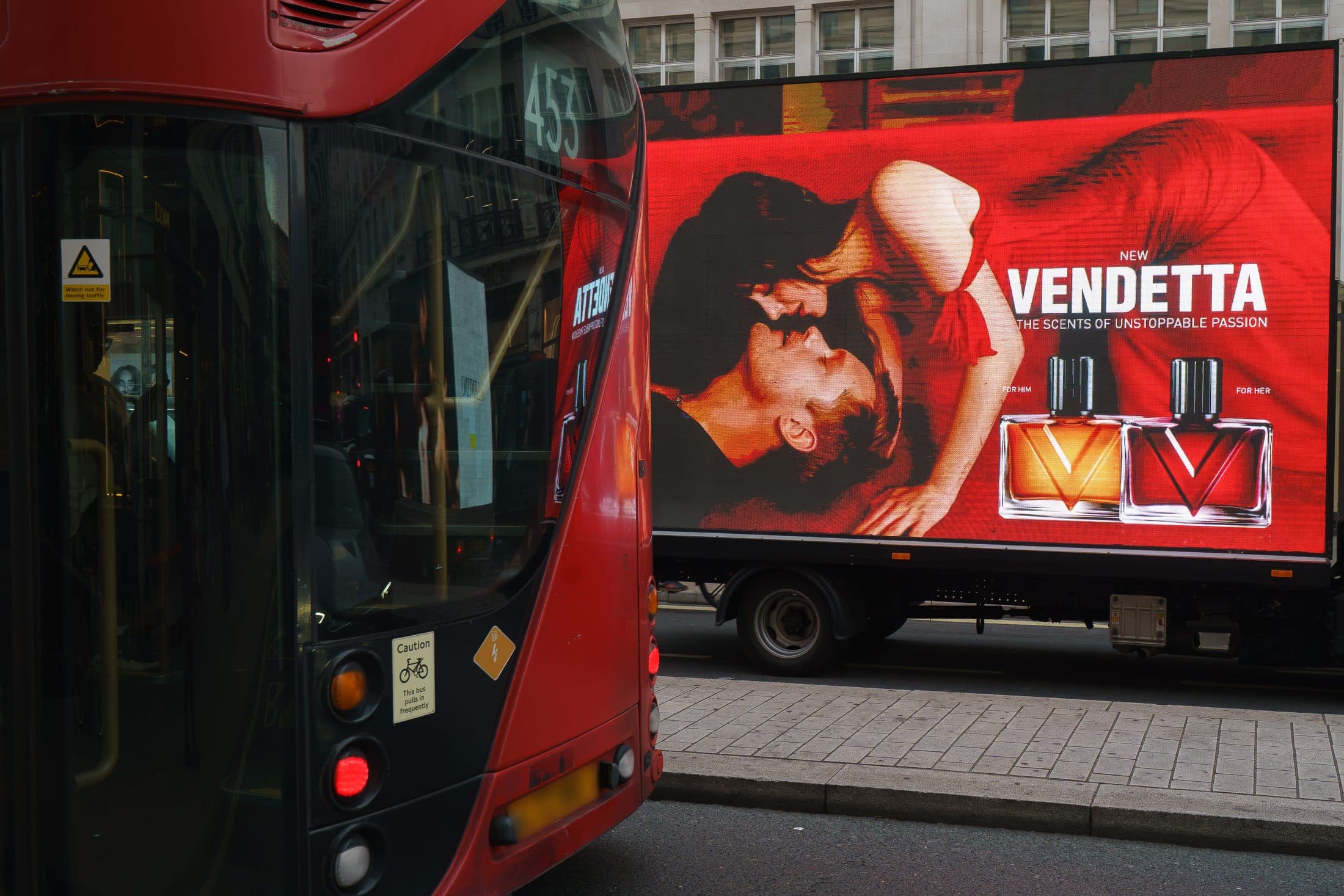A Monster Digital AdVan carrying the Valentino Vendetta campaign beside a red London bus on Regent Street