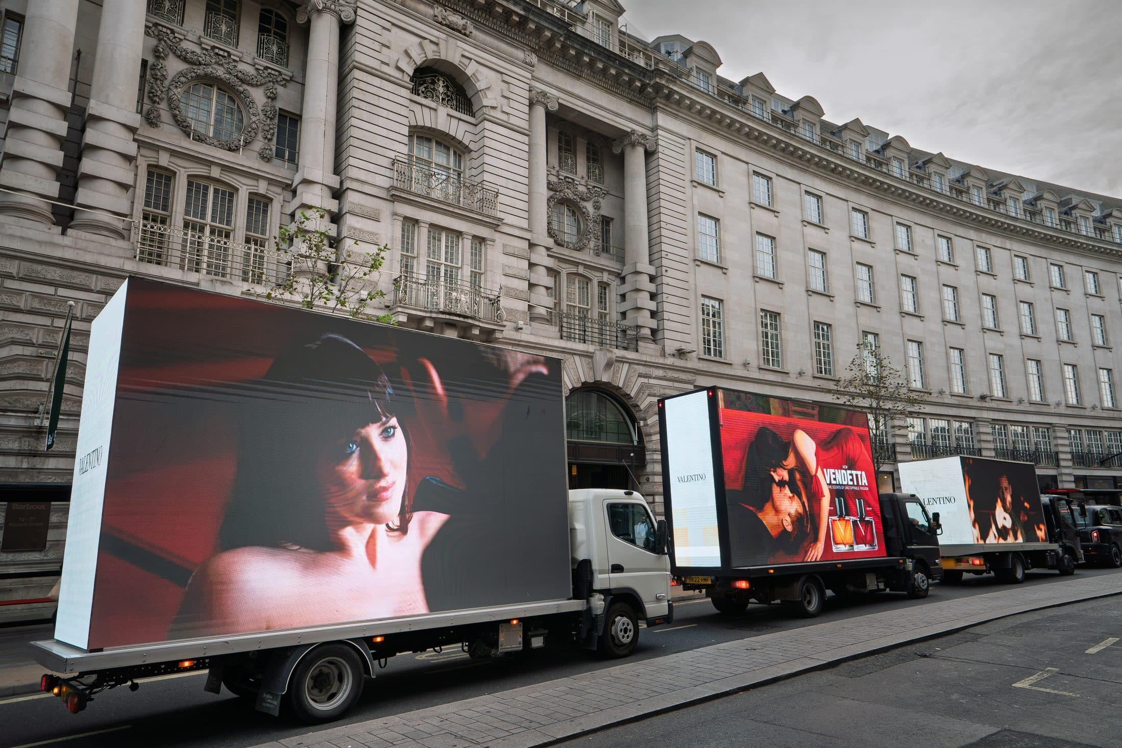 Three Monster Digital AdVans in convoy on Regent Street, each showing a different frame of the Valentino Vendetta campaign