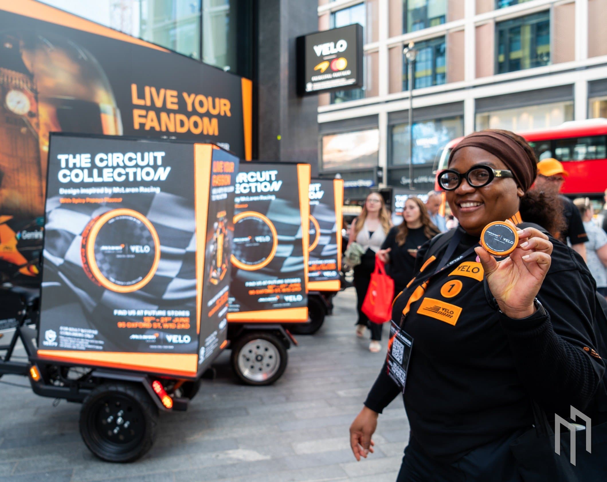 Live Your Fandom creative on Velo x McLaren Digital AdBikes outside the Future Stores pop-up