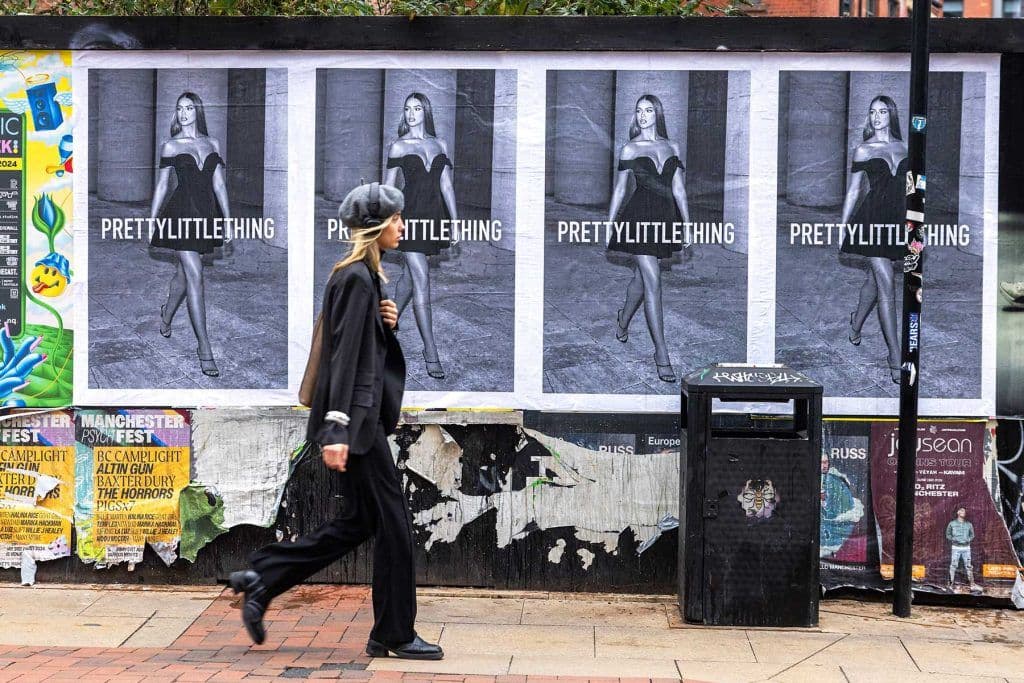 4-sheet flyposting block pasted in a run along a London hoarding
