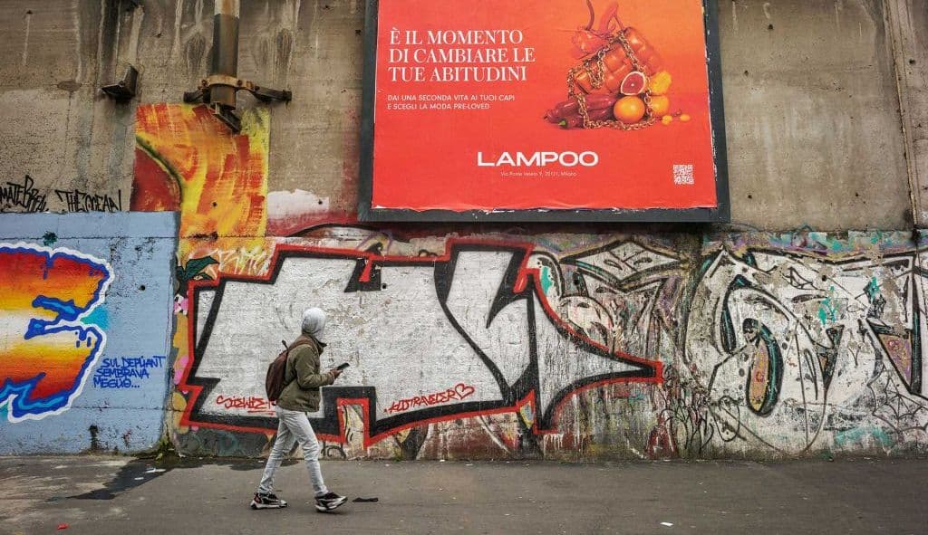 Full-wall megasite paper posting dominating a street corner