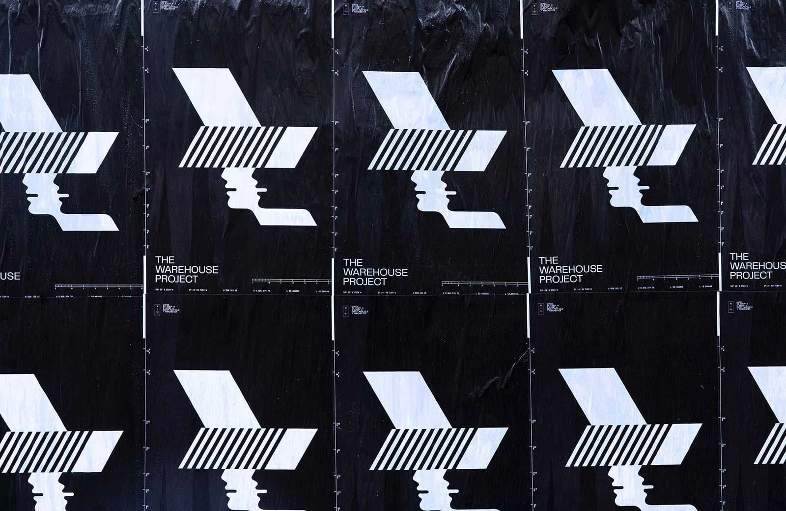 Wall of layered street posters pasted across a London hoarding