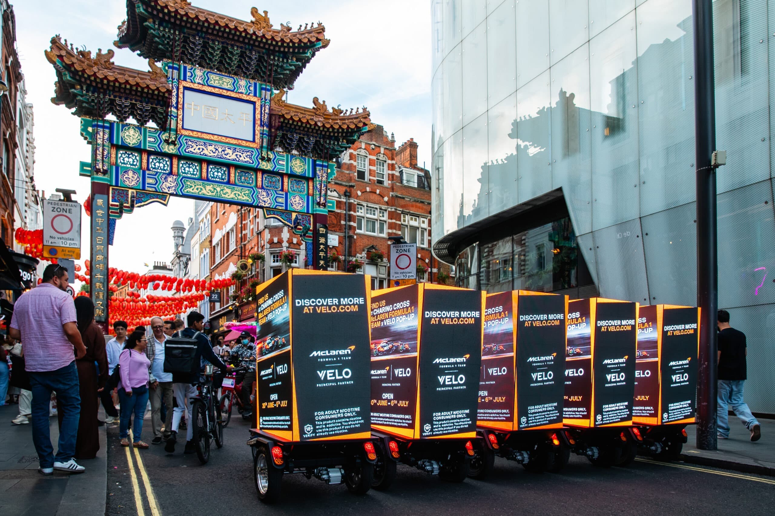 Velo × McLaren F1 mobile bike advertising with seven digital billboard bikes in London