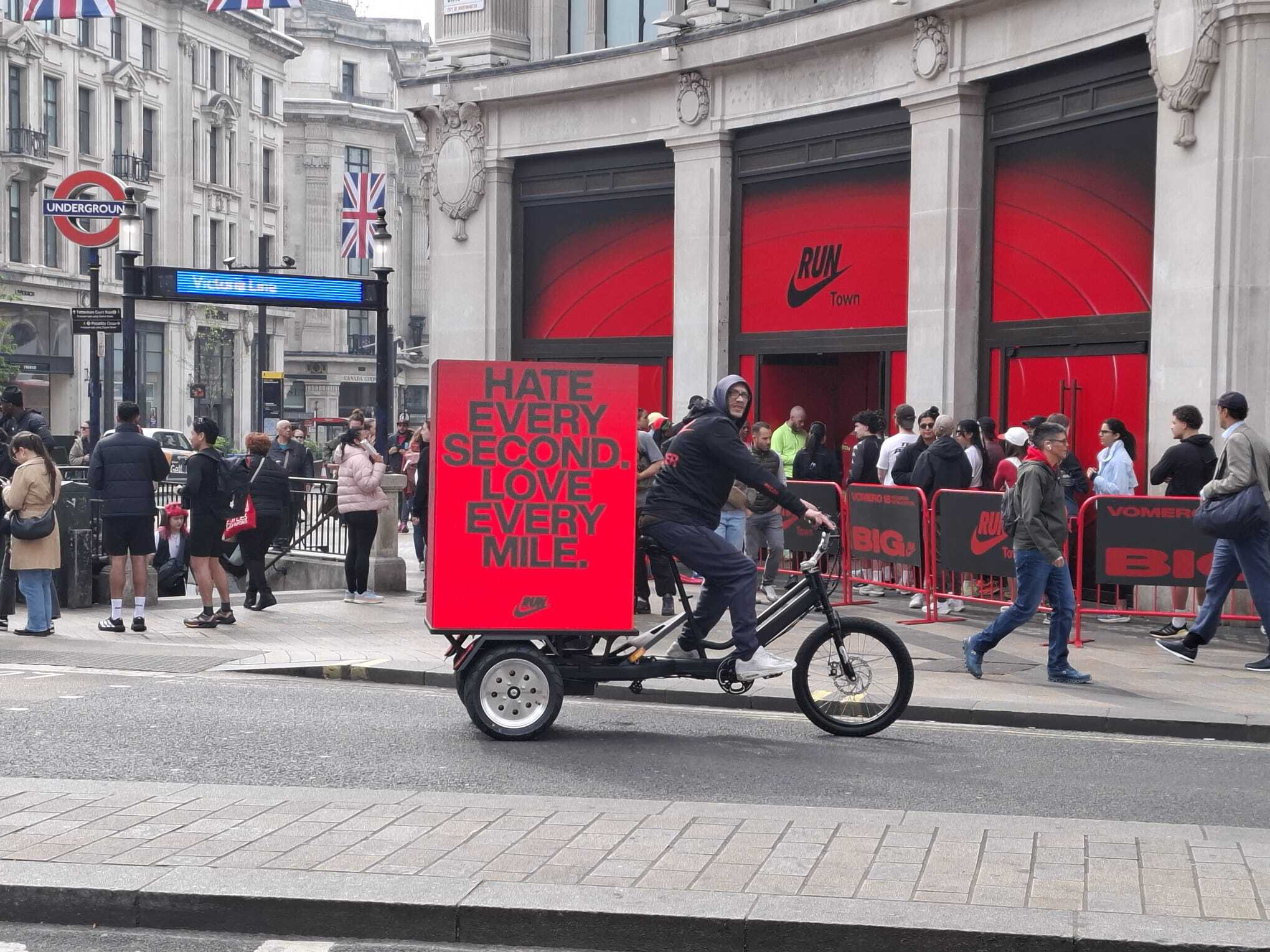 Nike RunTown digital billboard bike riding past the RunTown store at Oxford Circus, London