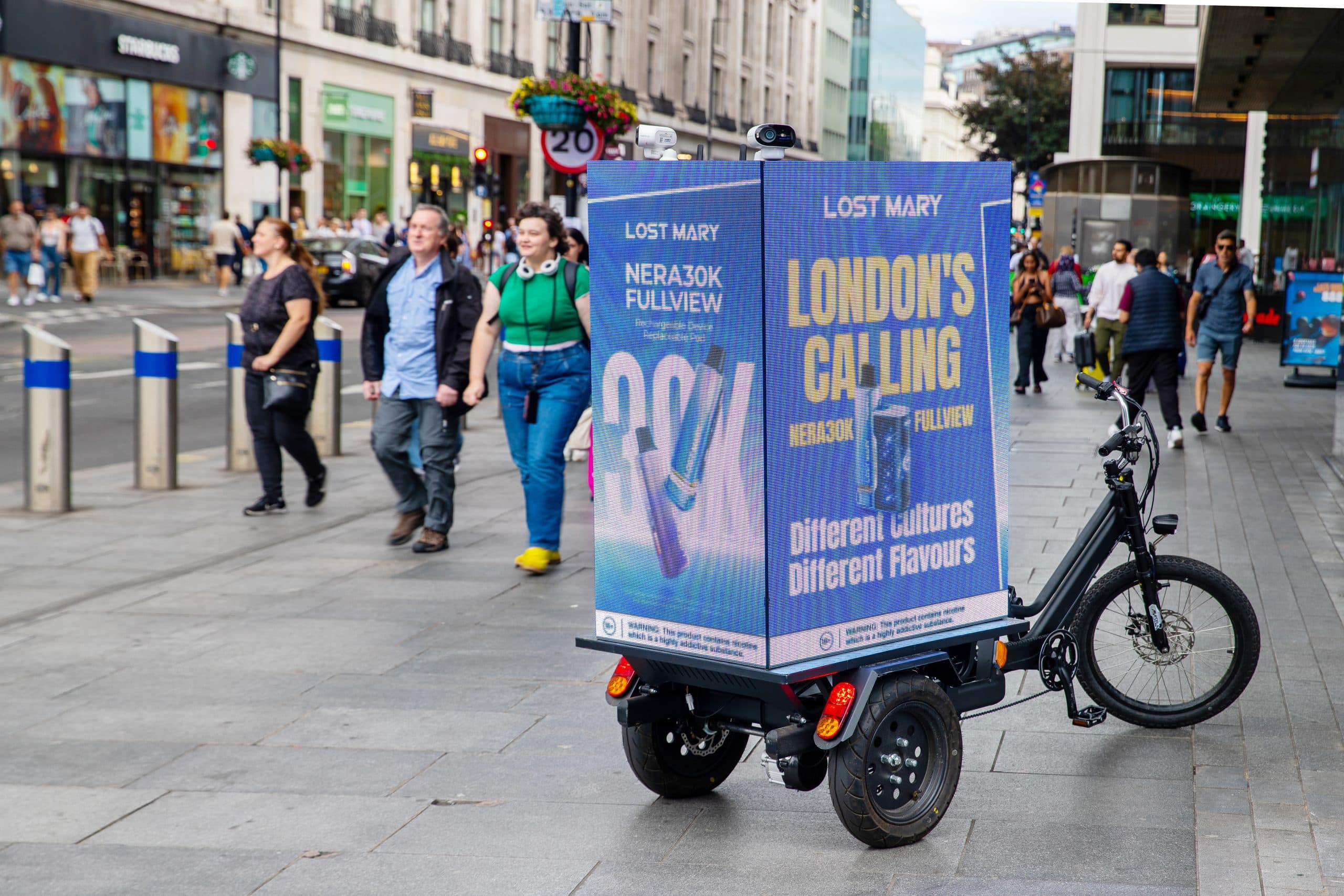 Digital AdBike advertising campaign riding through a UK city centre