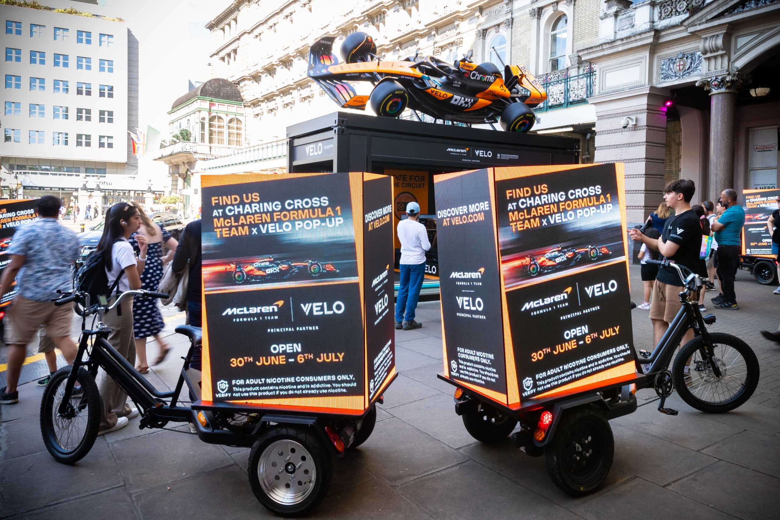 Velo x McLaren F1 Digital Billboard Bikes on a central London street