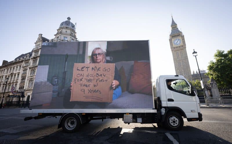 Seven synchronised Carers Trust Digital AdVans circling Parliament Square
