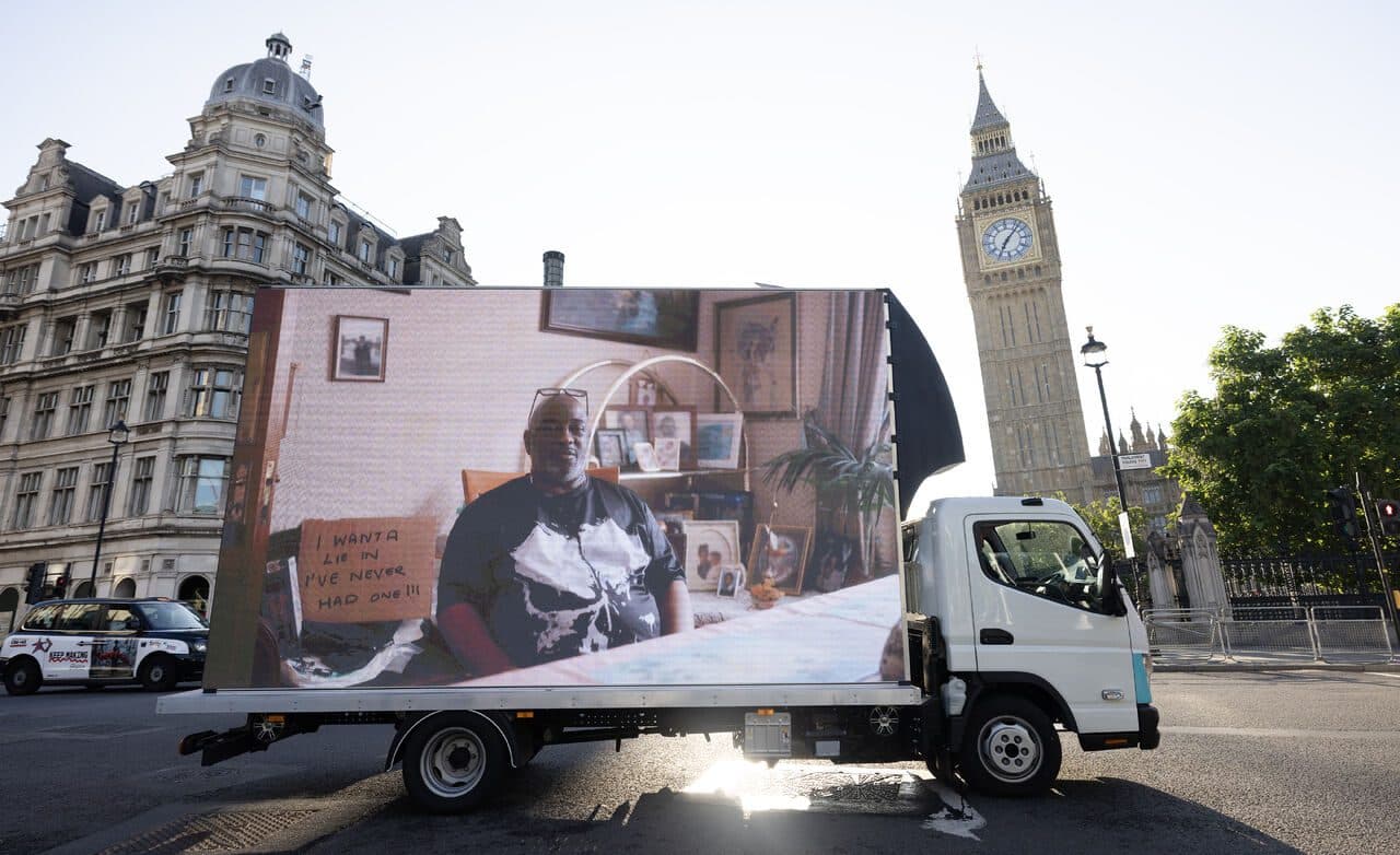 Carers Trust AdVan showing an unpaid carer on its LED screen beside Big Ben at Parliament Square